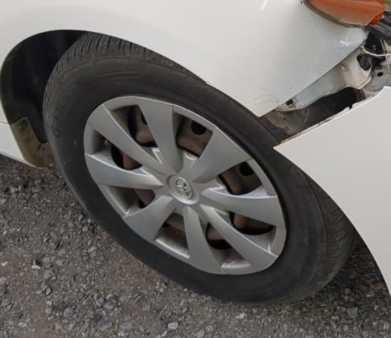 AI-cropped photo of the damaged front wheel well liner